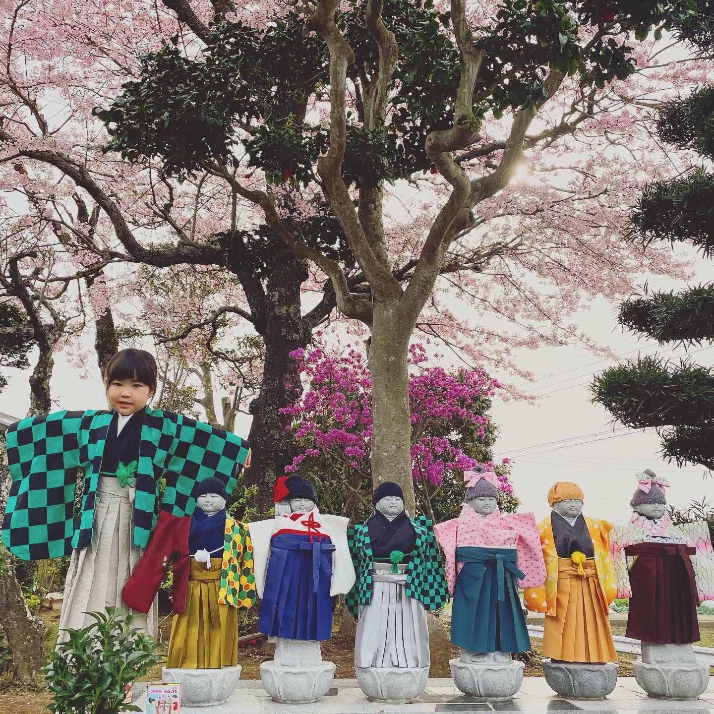 Six Jizo statues dressed in colorful costumes at Susono Komyoji Temple